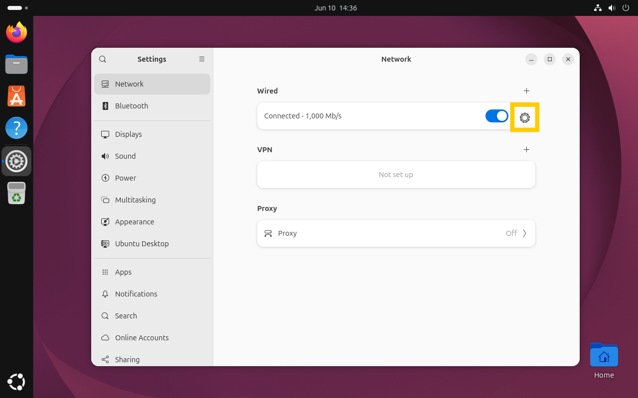 The Ubuntu Network settings window, with the gear icon next to the "Wired" connection toggle highlighted in a yellow box.