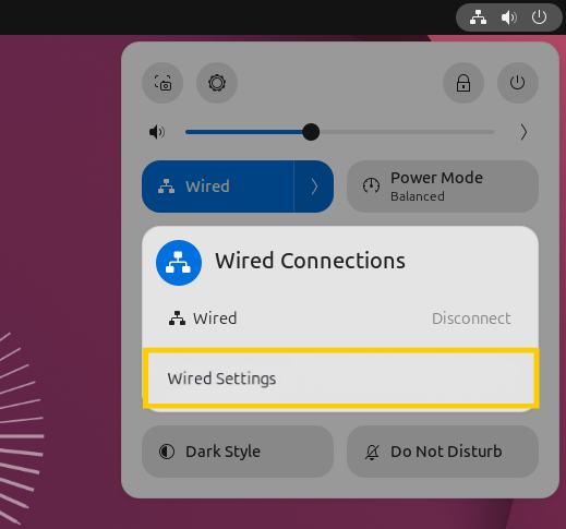 The expanded network quick settings menu in Ubuntu, with the "Wired Settings" option highlighted in a yellow box.